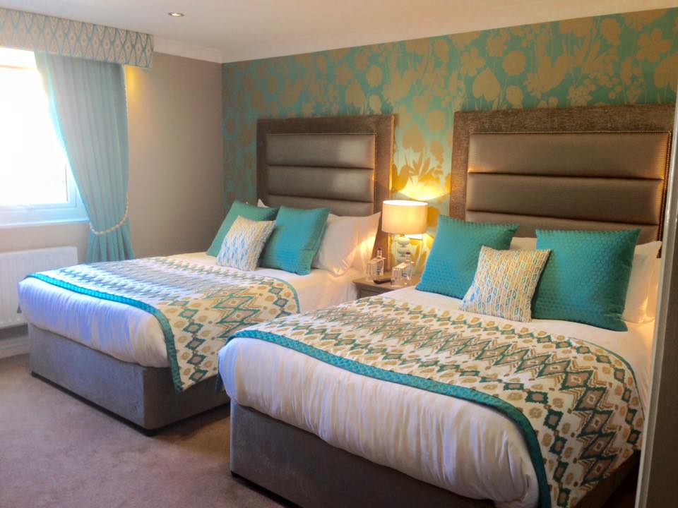 A twin bedroom with 2 double beds in the coach-house with Turquoise colour scheme at West Tower