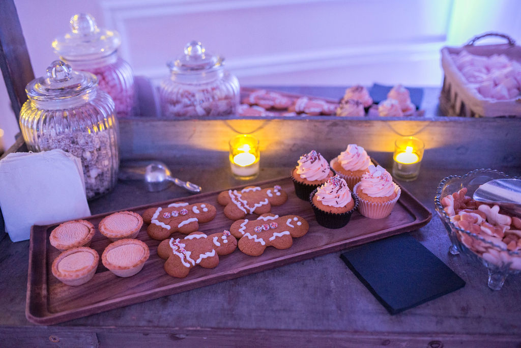 Selection of gingerbread men, mince pies and cupcakes on evening dessert table at West Tower