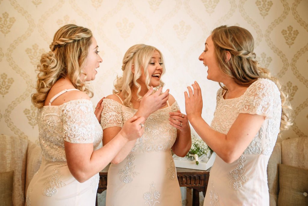 Bride & bridesmaids laughing in the bridal suite at West Tower for her spring wedding