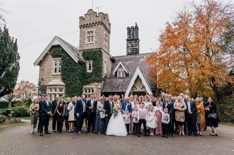 Bride & groom & bridal party in front of West Tower at their autumn wedding