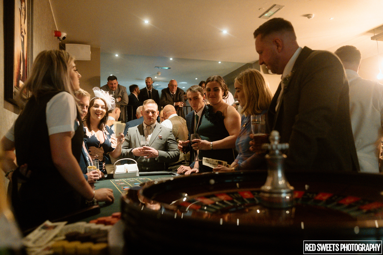 A casino table aid out surrounded by guests in the Cellar bar of west tower who are attending the wedding show