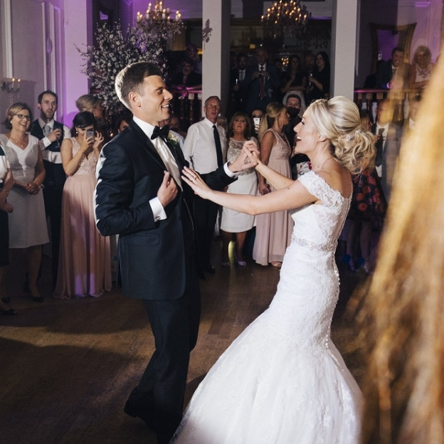 Wedding guests dancing and celebrating on the dance floor in the Ballroom at West Tower.