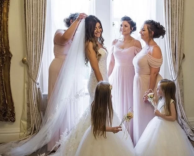 Bride getting ready with bridesmaids and flower girls in the Dom Perignon Bridal Suite at West Tower before the wedding ceremony.